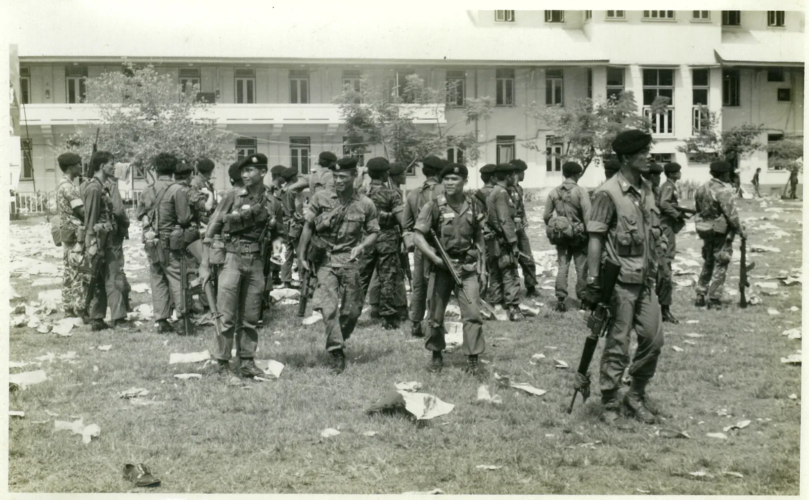 Armed Border Patrol Police gather on the litter strewn football field.