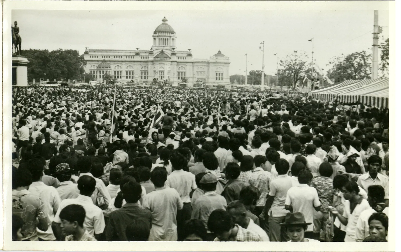 A dense crowd fills the Royal Plaza in front of the Ananta Samakhom Throne Hall.
